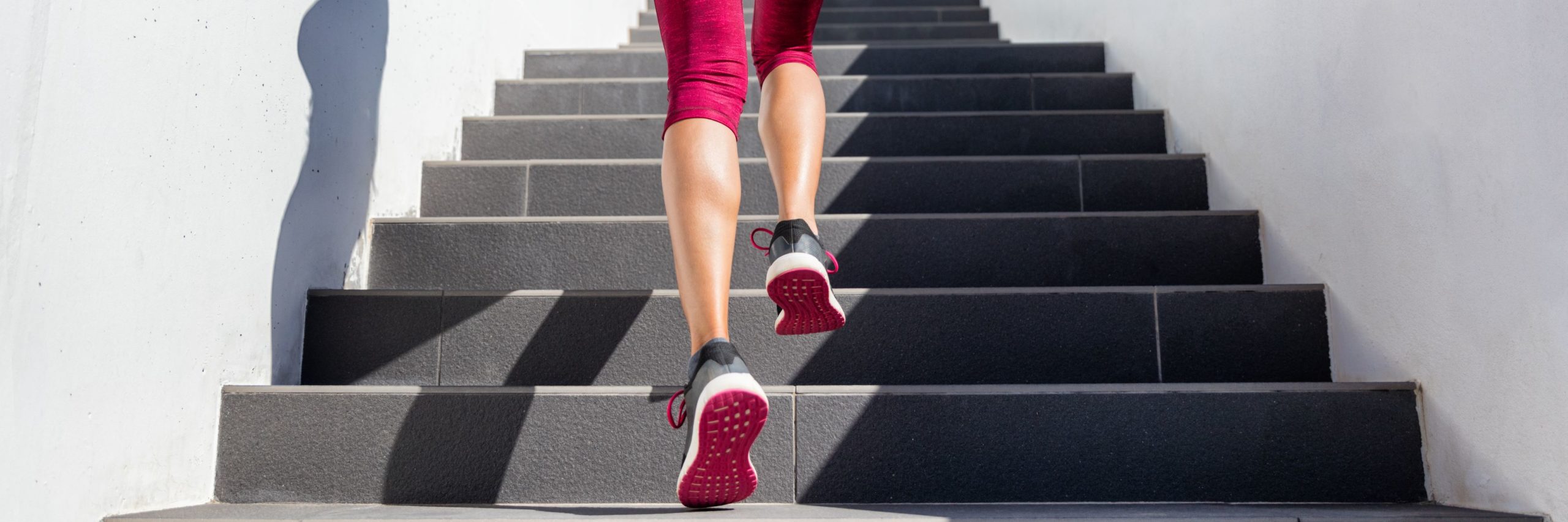 woman running up stairs interval training