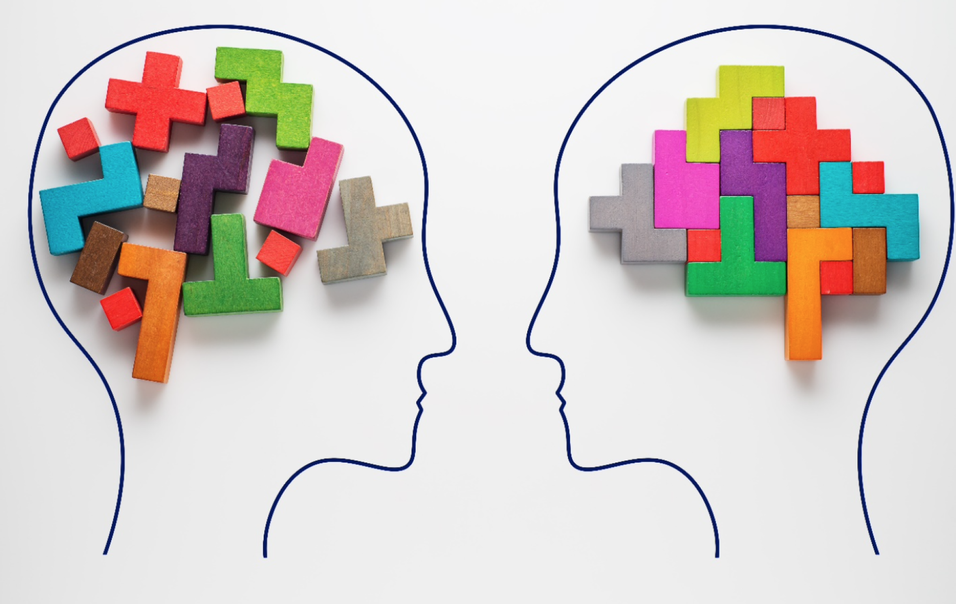 Two heads with different colored puzzles in the middle of each.