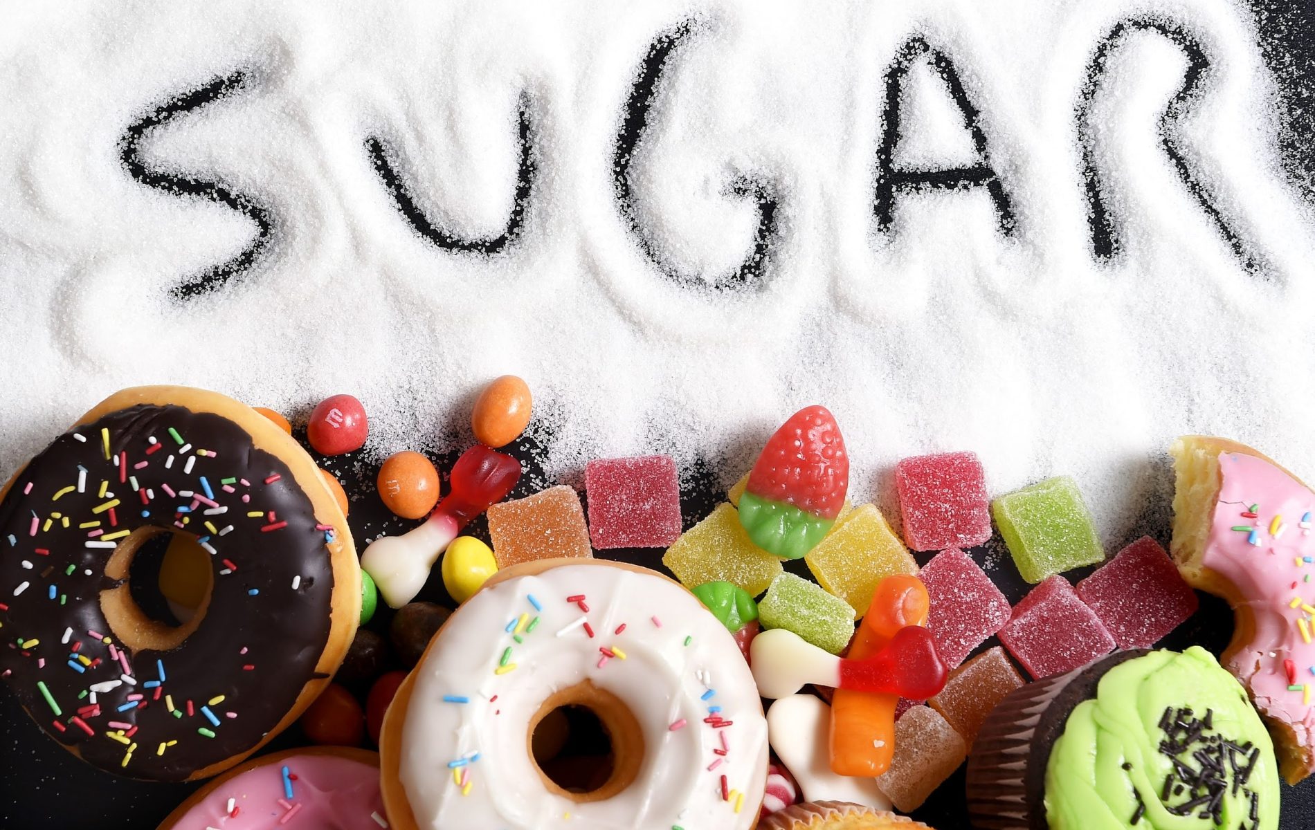 A pile of different types of sugar donuts.