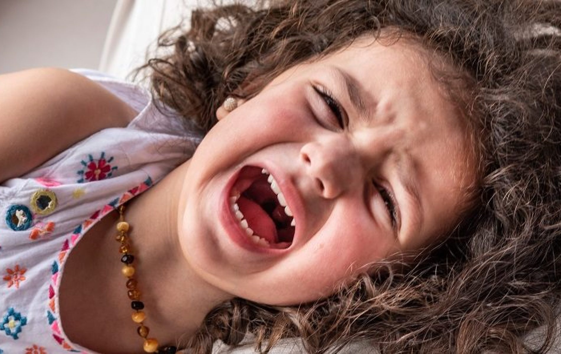 girl lying down having temper tantrum
